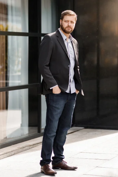 man wearing suit with an untucked shirt